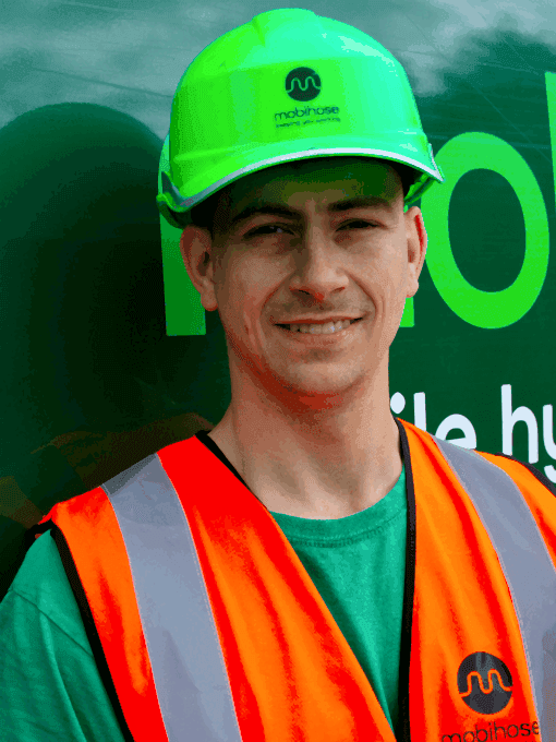 Alex Stephens, Mobihose engineer in front of green van.